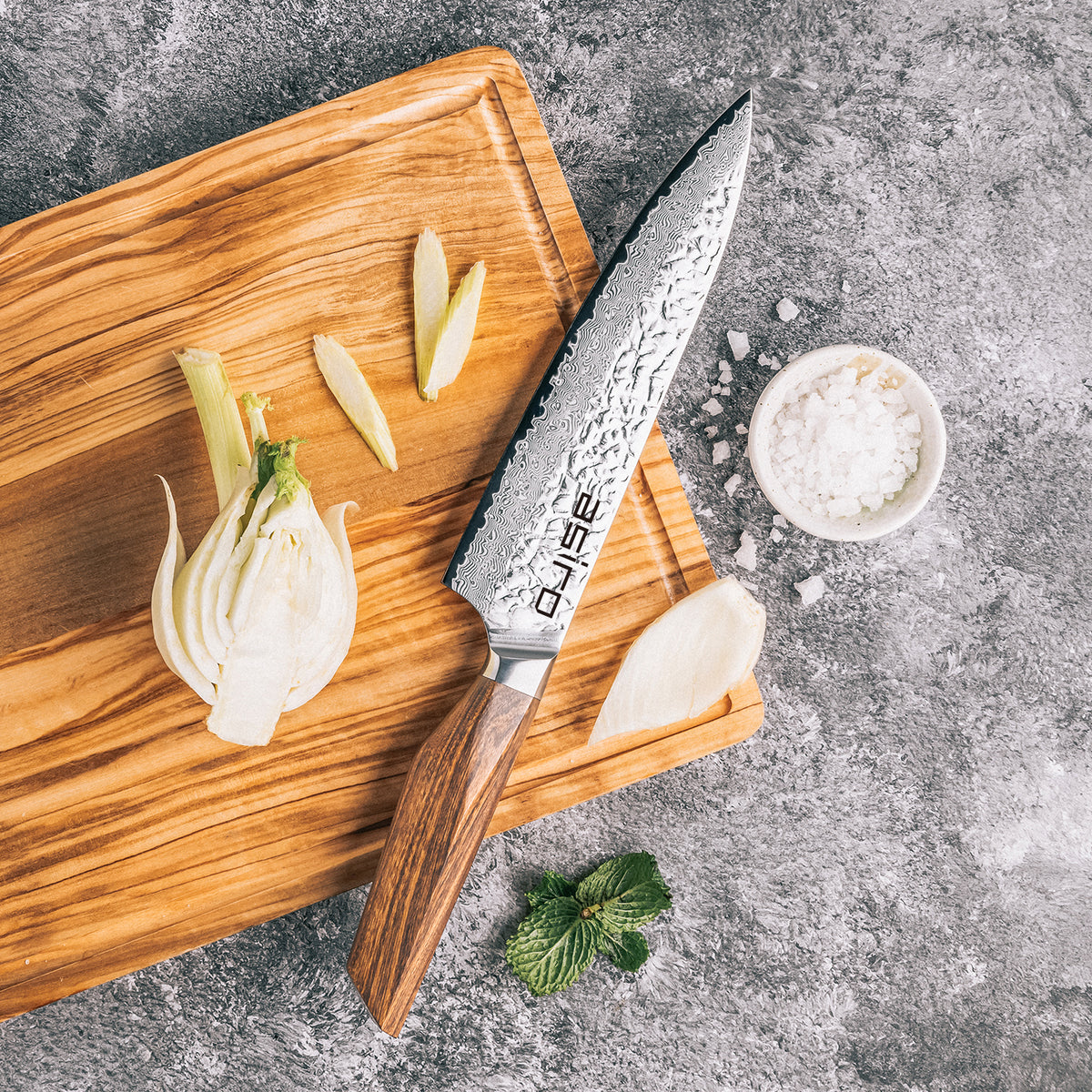 Asiro Chef Knife on olive wood board slicing fennel
