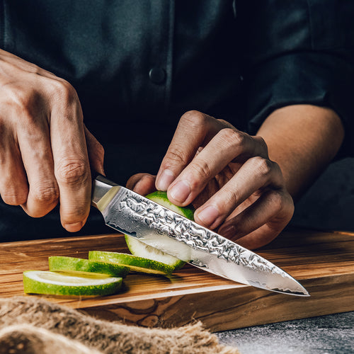Asiro Utility Knife standing on cutting board with fennel