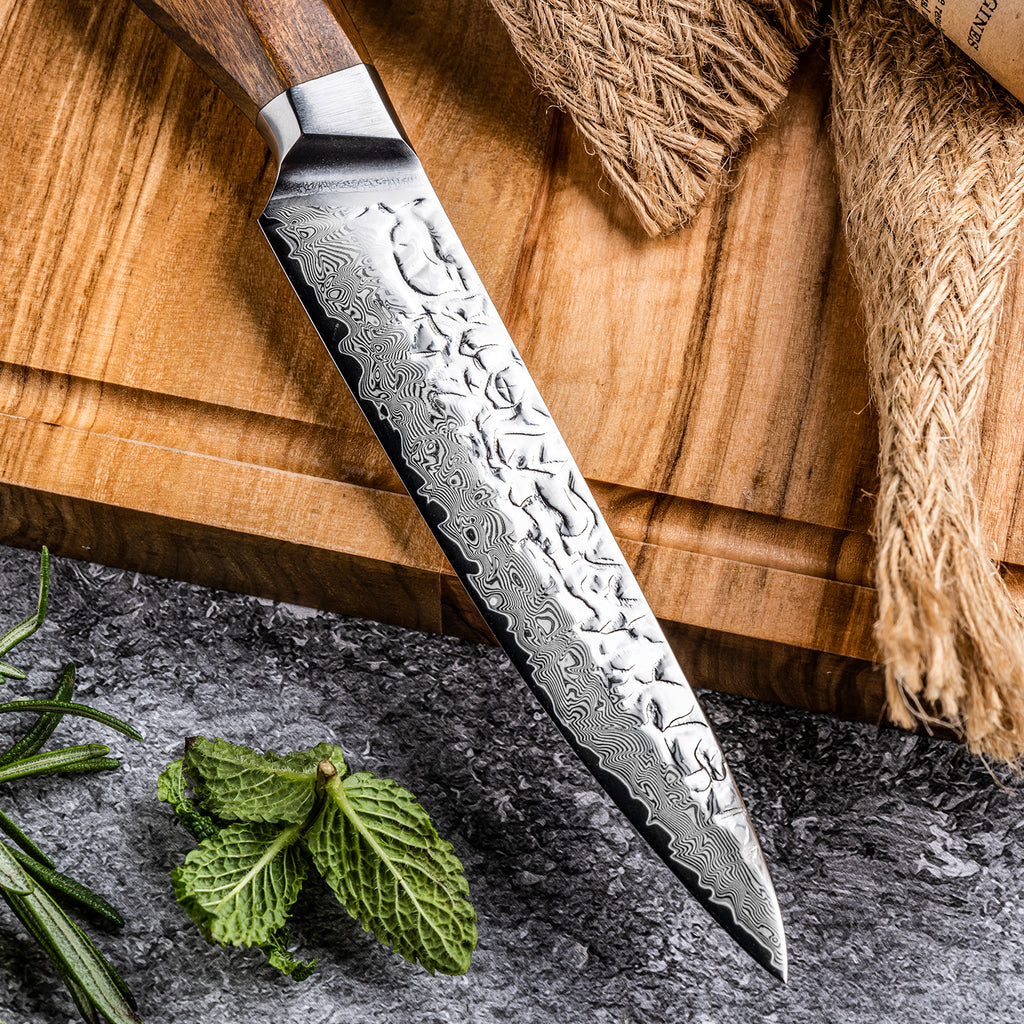 Asiro Utility Knife on olive wood board with fennel